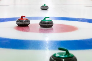 Deurstickers curling stones on the ice © ronstik