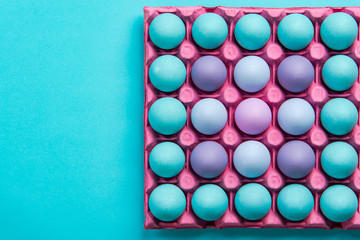 Colorful chicken eggs in tray