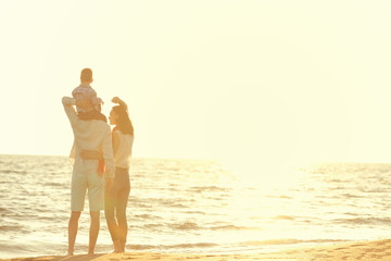 portrait of happy family and baby enjoying sunset in the summer leisure
