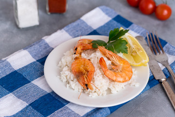Plate with fried prawns and rice. Seafood.