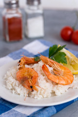 Plate with fried prawns and rice. Seafood.