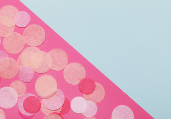 Pink confetti on pastel pink background. Festive background  for your design.