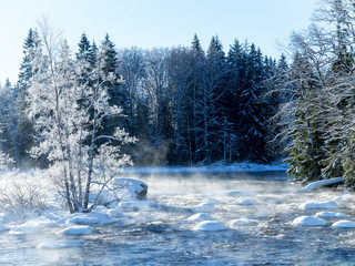Sunrise river in a cold winter landscape with snow and frost
