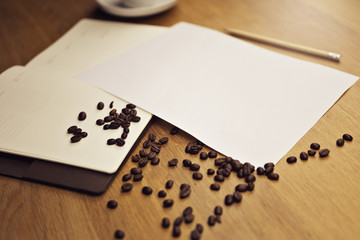 Blank paper with a notebook with a cup of coffee