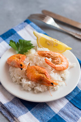 Plate with fried prawns and rice. Seafood.