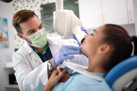 Dental doctor looking patient teeth