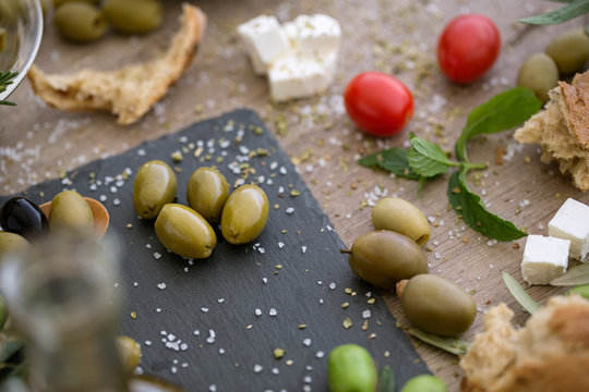 top view antioxidant green olives in black plate.