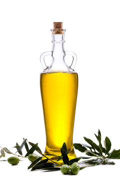 Glass Bottle with extra olive oil and olive branch isolated on a white.