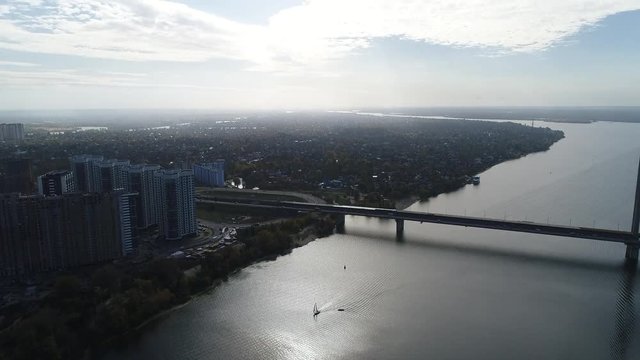 Aerial view. Flight over the city of Kiev, Ukraine. Video from copter. Flight over the Dnieper river near the South Bridge. View of the residential complex Zarechny. 4K, UHD, Ultra HD resolution