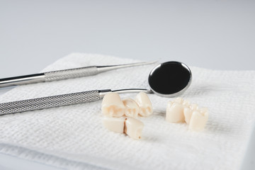Removed wisdom tooth on white napkin and dental equipment isolated on white background close-up....