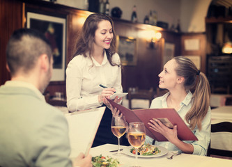 Hospitable waitress taking order