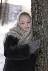 Beautiful little girl in shawl in winter