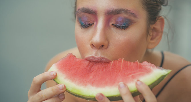 Young woman eat juicy watermelon