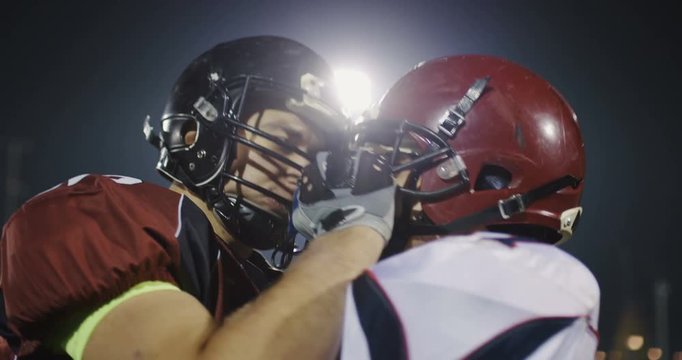 .Slow motion football players fight, engage and block