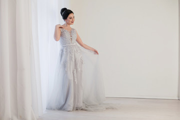 Fototapeta na wymiar bride in wedding dress in white room