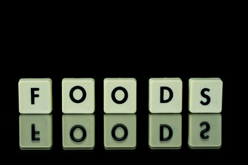 blocks with letters set on a glass table. Words arranged from letters on a glass substrate. The...