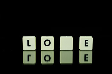 blocks with letters set on a glass table. Words arranged from letters on a glass substrate. The...