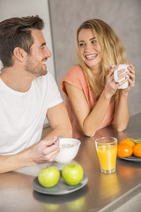 Obraz na płótnie Canvas Cheerful couple having breakfast together