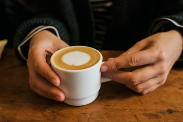 Fototapeta na wymiar Girl holding a hot cup of coffee