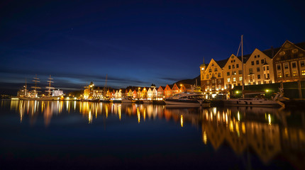 Fototapeta na wymiar A night long exposure photography of Bergen at harbor with beautiful water reflection