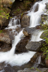 A mountain waterfall with milky water