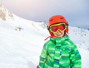 Fototapeta na wymiar Skier boy in a winter ski resort.