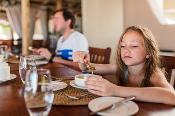 Obraz na płótnie Canvas Little girl eating breakfast