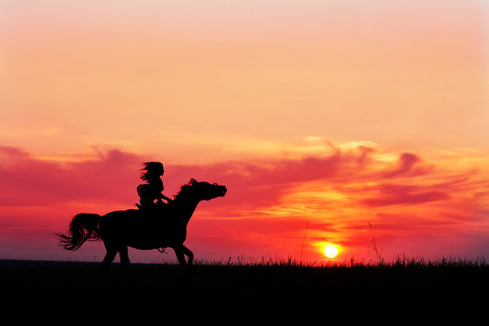 Romantic pink sunset with galloping horse and female silhouette. Horseback riding on rising sun horizon. Arabian horse safari on colorful sunset background. 