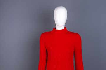 Mannequin in red fashion turtleneck sweater. Stylish spring pullover for women. Ladies classy outfit.