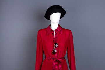 Female hat, red blouse and sunglasses. Mannequin dressed in elegant feminine clothes and accessories. Ladies fashion look.