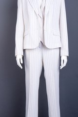 White blazer and white trousers for women. Female mannequin in white formal suit. Office style outfit.
