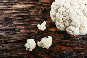 Cauliflower isolated on wood background, top view, close up.