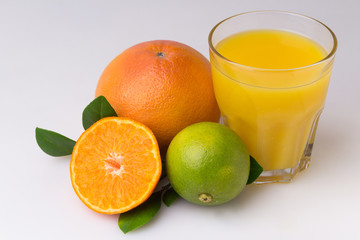 Glass of fresh citrus fruit Juice with green leaf isolated on white background
