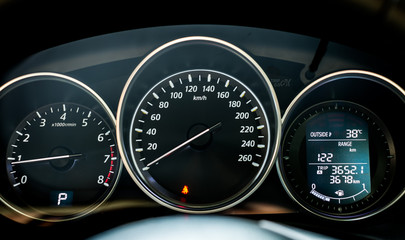 Close up of modern car dashboard with digital and analog display