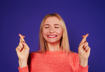 blond with crossed fingers