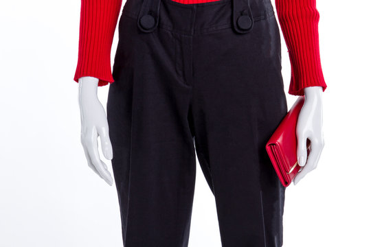 Close up black trousers and red wallet. Black cotton trousers for women. Female fashion style.
