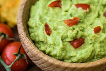 Close Up Detail of Guacamole in Wooden Bowl