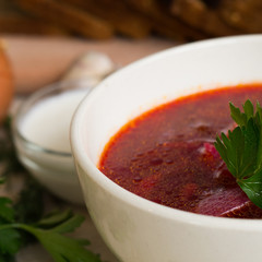 Borsch - beetroot soup in a clay bowl on a slate,stone or metal background,traditional dish of ukrainian cuisine.Top view.