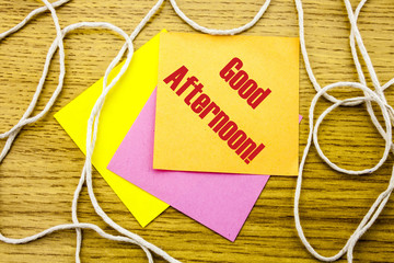 Good Afternoon word on yellow sticky note in wooden background. Bussines concept.