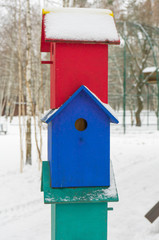 Colorful birdhouses for the birds in snow.