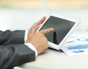 closeup.of businessman hand working with tablet computer