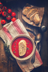 Tomato  soup  and fresh tomatoes cherry  on a wooden background Gazpacho Toned image Vintage style
