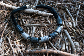 Necklace on forest ground. Handmade jewelry of polymer clay. Black silver disco necklace.