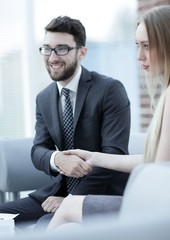 close-up of a manager shakes hands with a regular customer.