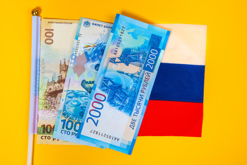 Russian banknotes of a new type. Money of Russia. New notes of Russian money on the flag of the Russian Federation.