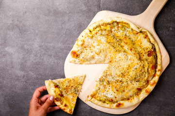 Pizza Four Cheeses with a Vessel Assortment on the Stone Background Baking Women's Hands Cut Snack  Top View Copy space for Text