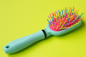 bright comb for hair on a pastel background