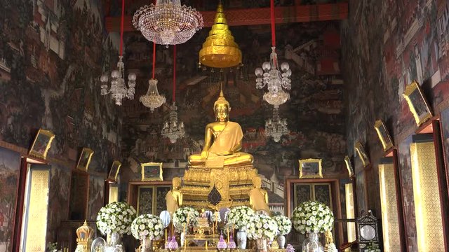 a gold buddha statue in the ordination hall of wat arun temple in bangkok, thailand