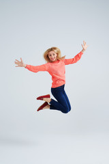 Fototapeta na wymiar happy blond jumping in studio