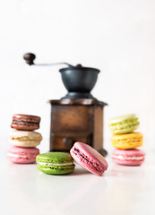 Colorful french macarons with coffee grinder
